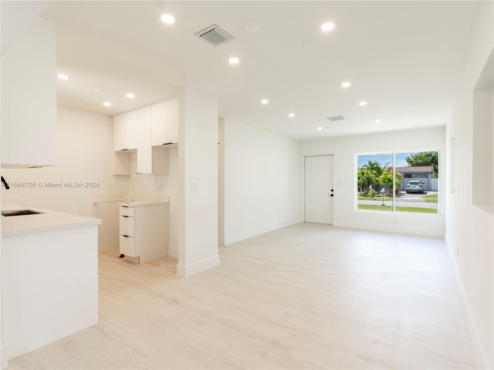11561 Southwest 187th Street Miami, FL 33157 - Photo 10 of 35 a view of a kitchen with a stove and a refrigerator