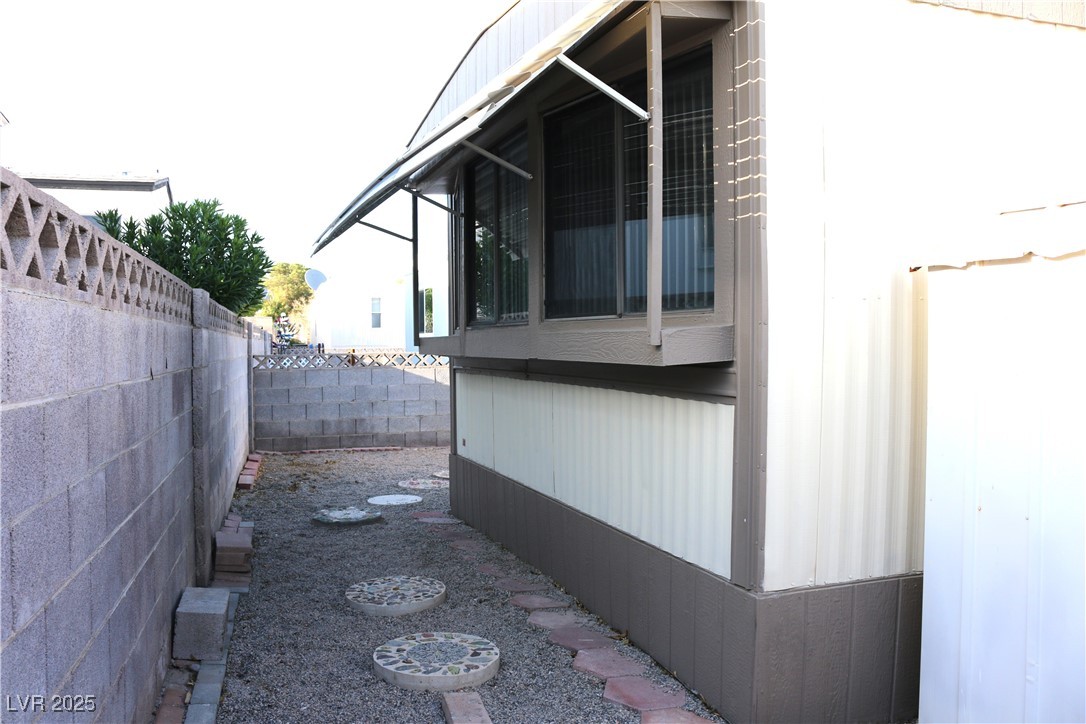 4633 Royal Ridge Boulevard Las Vegas, NV 89103 - Photo 13 of 13 View of side of property with a fenced backyard