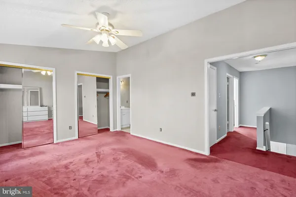a view of a livingroom with an empty space and a ceiling fan