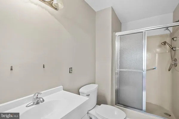 a white toilet sitting next to a bathroom sink