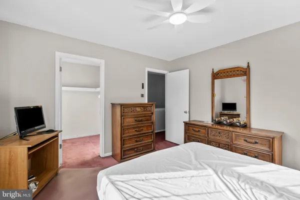 a bedroom with a bed and a television