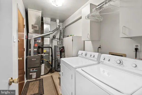 a view of storage and utility room with washer and dryer