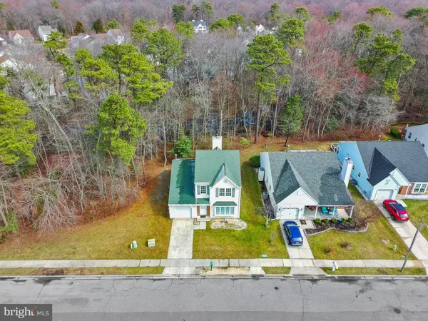 an aerial view of a house with a garden and lake view