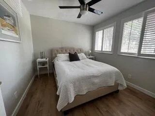 a bed sitting in a bedroom next to a window