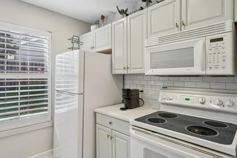 a kitchen with appliances cabinets and a counter top space
