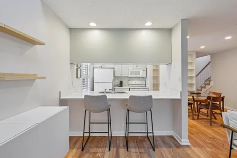 a view of a kitchen with dining table and chairs