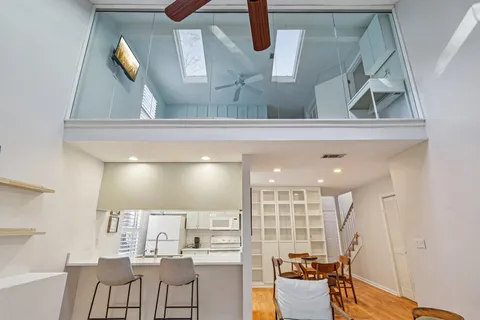 a view of a living room and kitchen with furniture