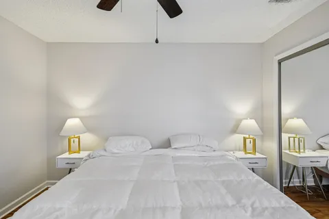 a bedroom with a bed and a lamp on table