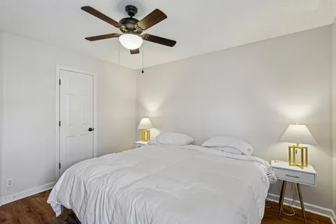 a bedroom with a bed and a ceiling fan