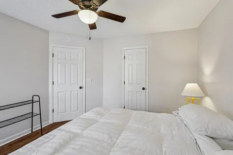 a bedroom with a bed and a chandelier