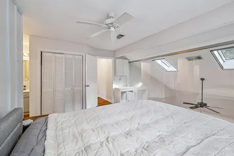 a bedroom with a large bed and a chandelier