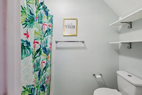a bathroom with a lot of flowers on the wall