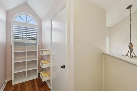 a view of a livingroom with wooden floor and a window