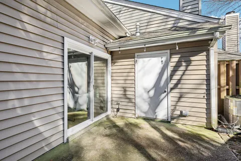 a view of a house with a door and wooden walls