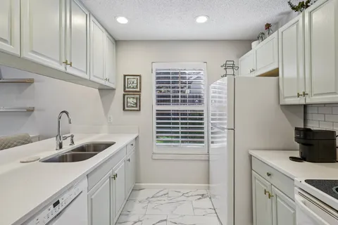 a kitchen with a sink and cabinets