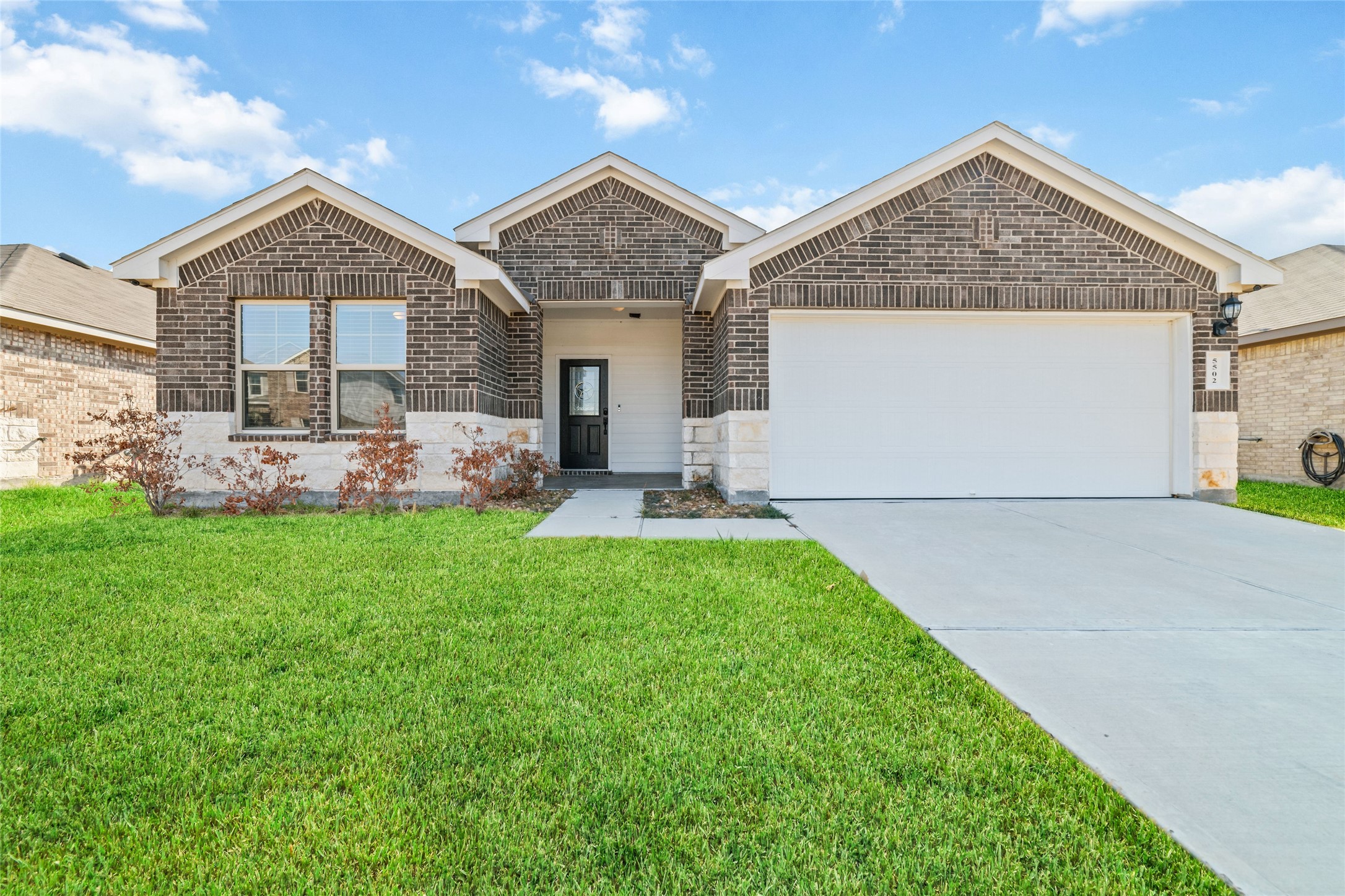 5502 Creekside Ridge Trail Katy, TX 77449 - Photo 1 of 25 a front view of a house with garden
