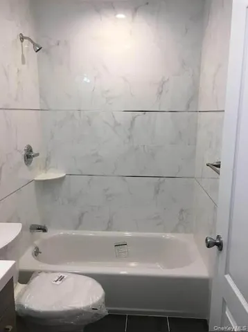 a bathroom with a bathtub and a toilet