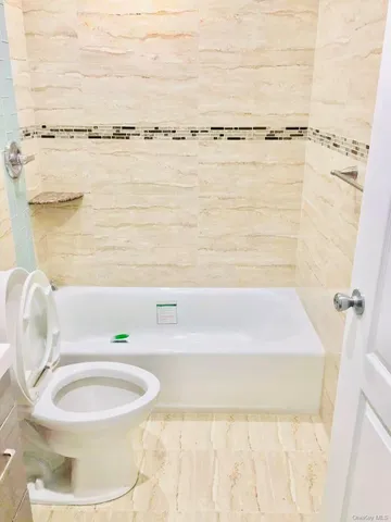 a bathroom with a bathtub and shower