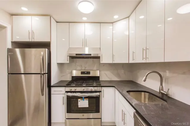 a kitchen with stainless steel appliances granite countertop a refrigerator sink and cabinets