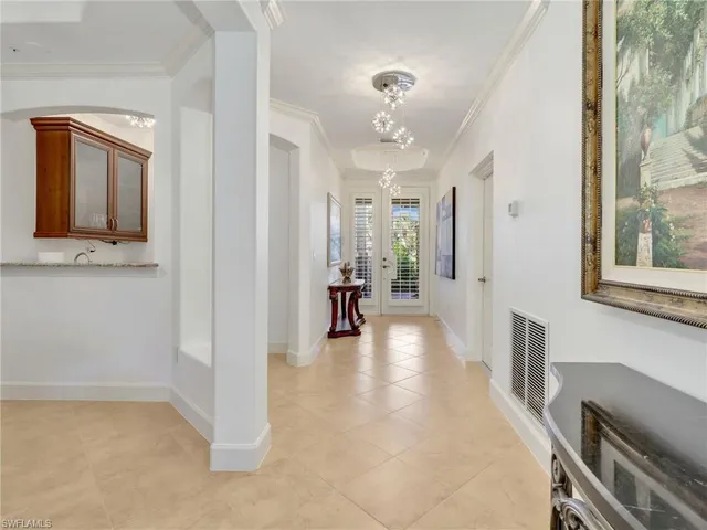 a view of a hallway with wooden floor and a living room