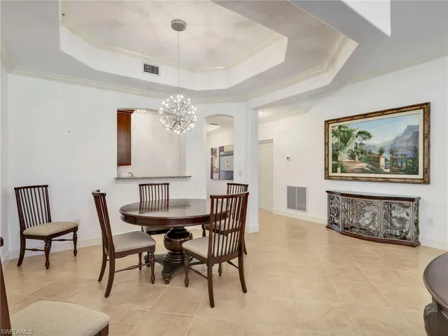 a view of a dining room with furniture and a chandelier