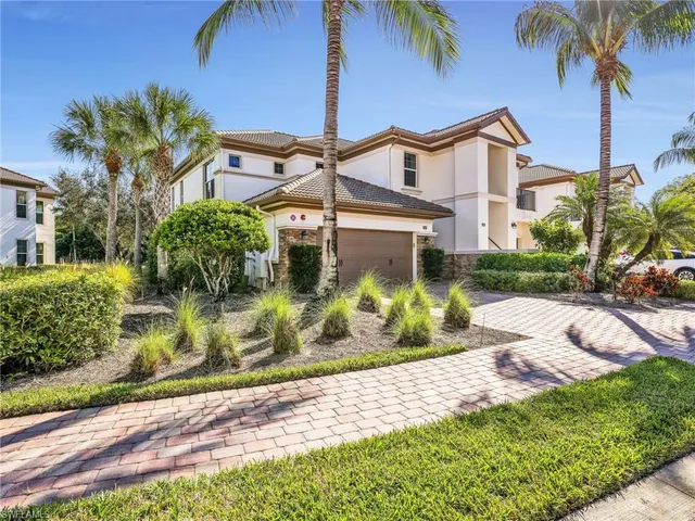 a front view of a house with a garden and plants