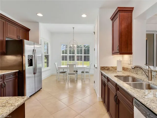 a kitchen with a refrigerator a sink and a stove