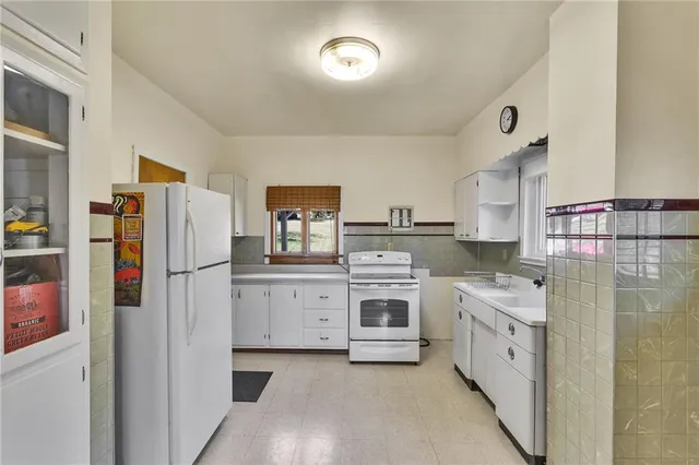a kitchen with a stove top oven sink and refrigerator