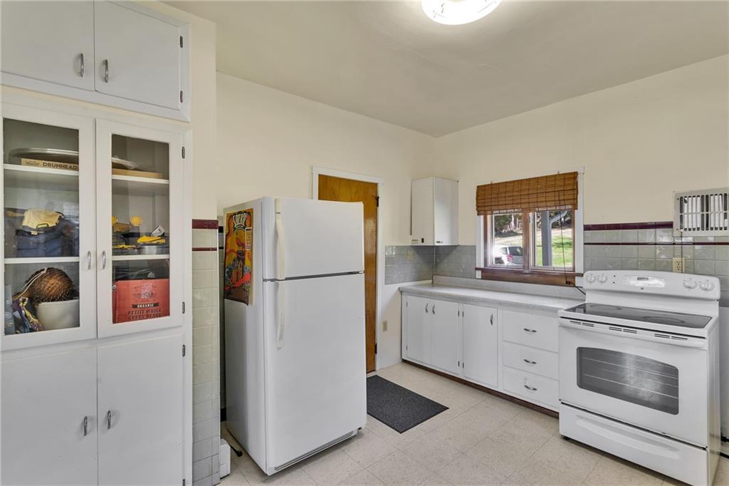 4032 Ewalt Road Gibsonia, PA 15044 - Photo 12 of 40 a kitchen with a refrigerator sink and cabinets