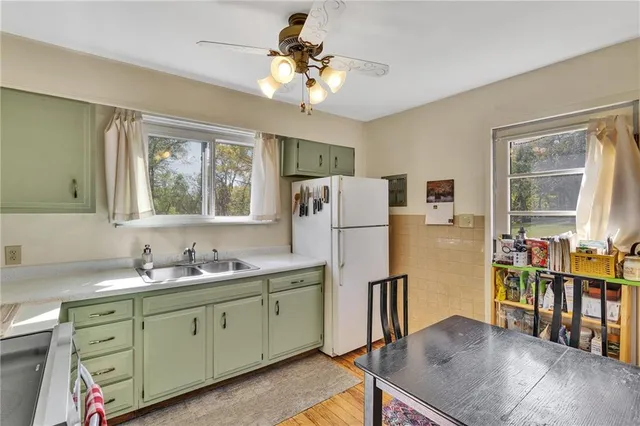 a kitchen with refrigerator a sink and cabinets