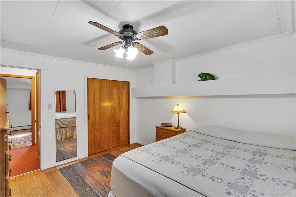 4032 Ewalt Road Gibsonia, PA 15044 - Photo 32 of 40 a bedroom with a bed and a chandelier