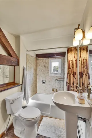 a bathroom with a sink a toilet and a mirror