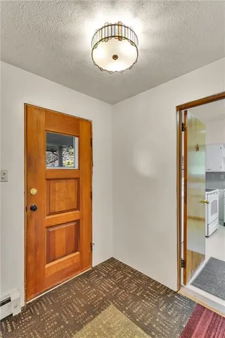 a view of a bedroom with a bed and a mirror