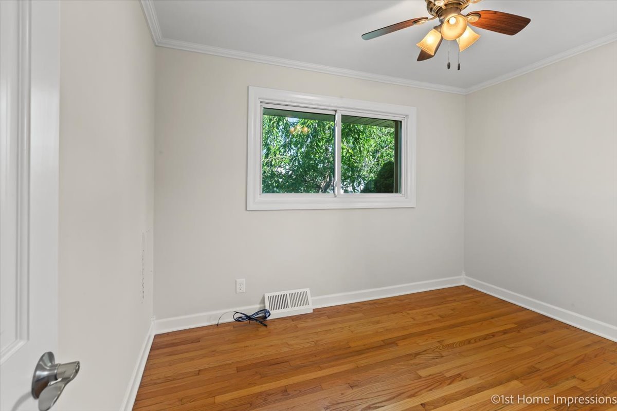 10937 Austin Avenue Chicago Ridge, IL 60415 - Photo 13 of 26 an empty room with a window and a ceiling fan