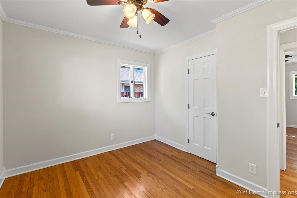 10937 Austin Avenue Chicago Ridge, IL 60415 - Photo 14 of 26 wooden floor in an empty room with a window