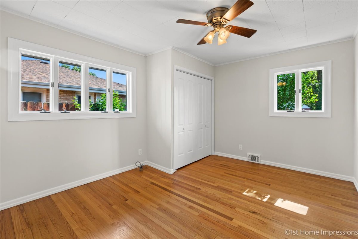 10937 Austin Avenue Chicago Ridge, IL 60415 - Photo 15 of 26 a view of empty room with wooden floor and fan