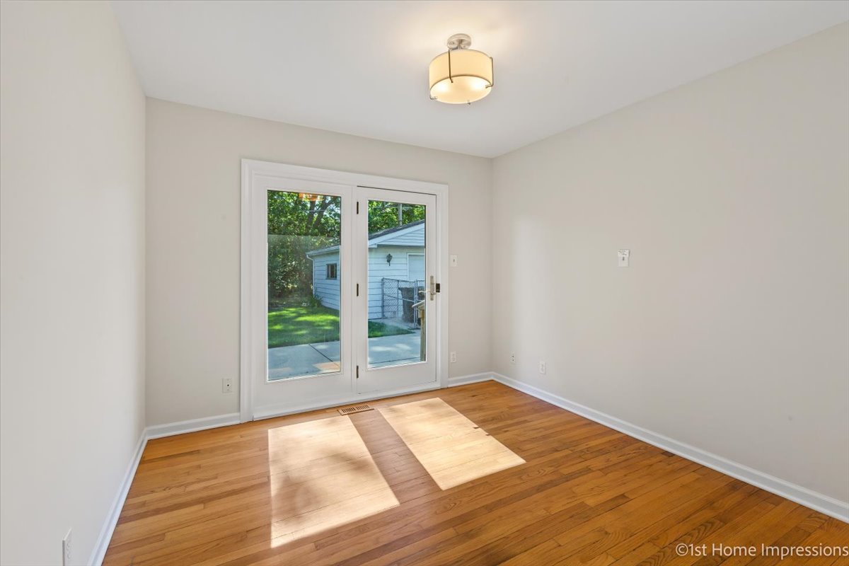 10937 Austin Avenue Chicago Ridge, IL 60415 - Photo 17 of 26 an empty room with wooden floor and windows