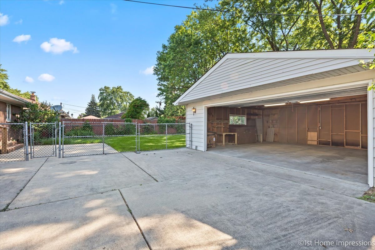 10937 Austin Avenue Chicago Ridge, IL 60415 - Photo 21 of 26 a view of a house with a yard and garage