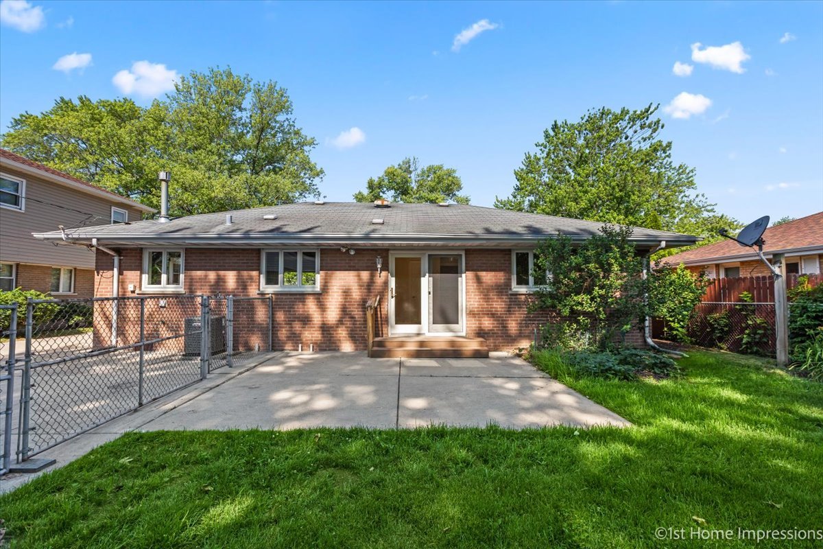 10937 Austin Avenue Chicago Ridge, IL 60415 - Photo 26 of 26 a front view of a house with a garden