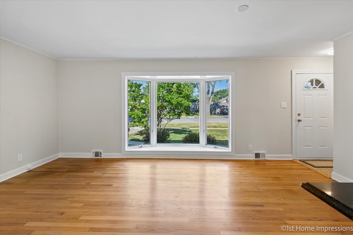 10937 Austin Avenue Chicago Ridge, IL 60415 - Photo 5 of 26 a view of wooden floor and windows in a room