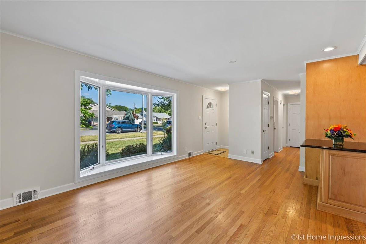10937 Austin Avenue Chicago Ridge, IL 60415 - Photo 6 of 26 a view of an empty room with a window and wooden floor