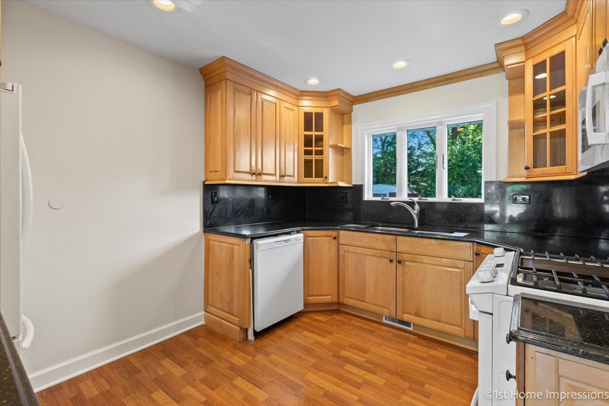 10937 Austin Avenue Chicago Ridge, IL 60415 - Photo 8 of 26 a kitchen with stainless steel appliances granite countertop a stove a sink and a microwave