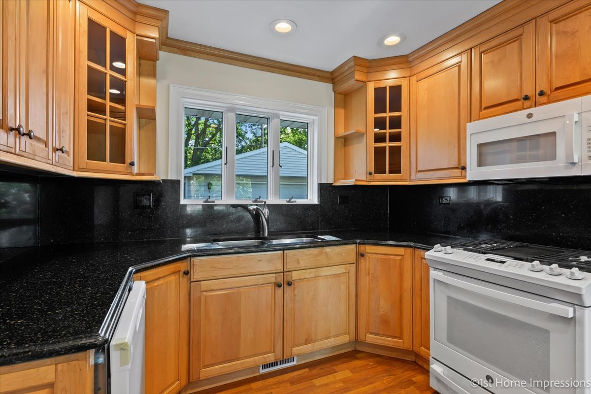 10937 Austin Avenue Chicago Ridge, IL 60415 - Photo 10 of 26 a kitchen with granite countertop a stove a sink and a microwave