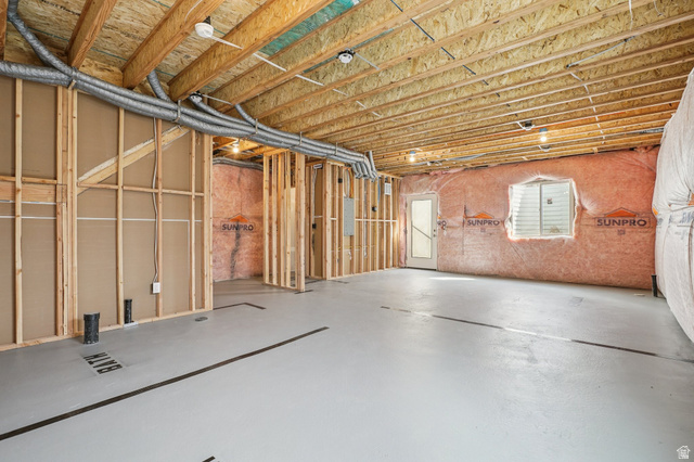 2097 North Ostler Peak Road, Unit 115 Heber City, UT 84032 - Photo 15 of 33 Unfinished basement with exposed wooden joists, framed interior walls, and a window with blinds