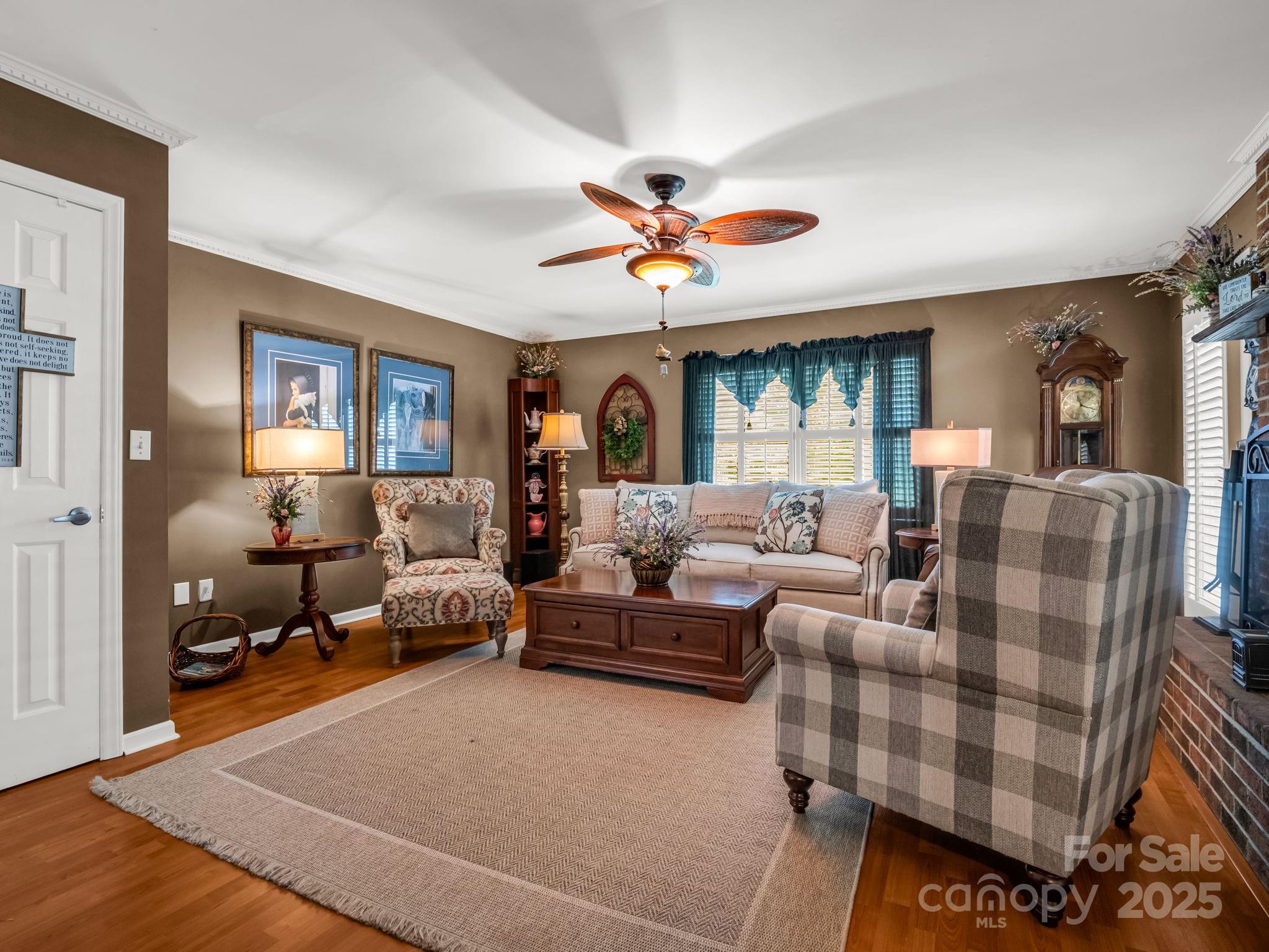 130 Briarwood Drive Rutherfordton, NC 28139 - Photo 5 of 48 a living room with furniture a fireplace and a chandelier