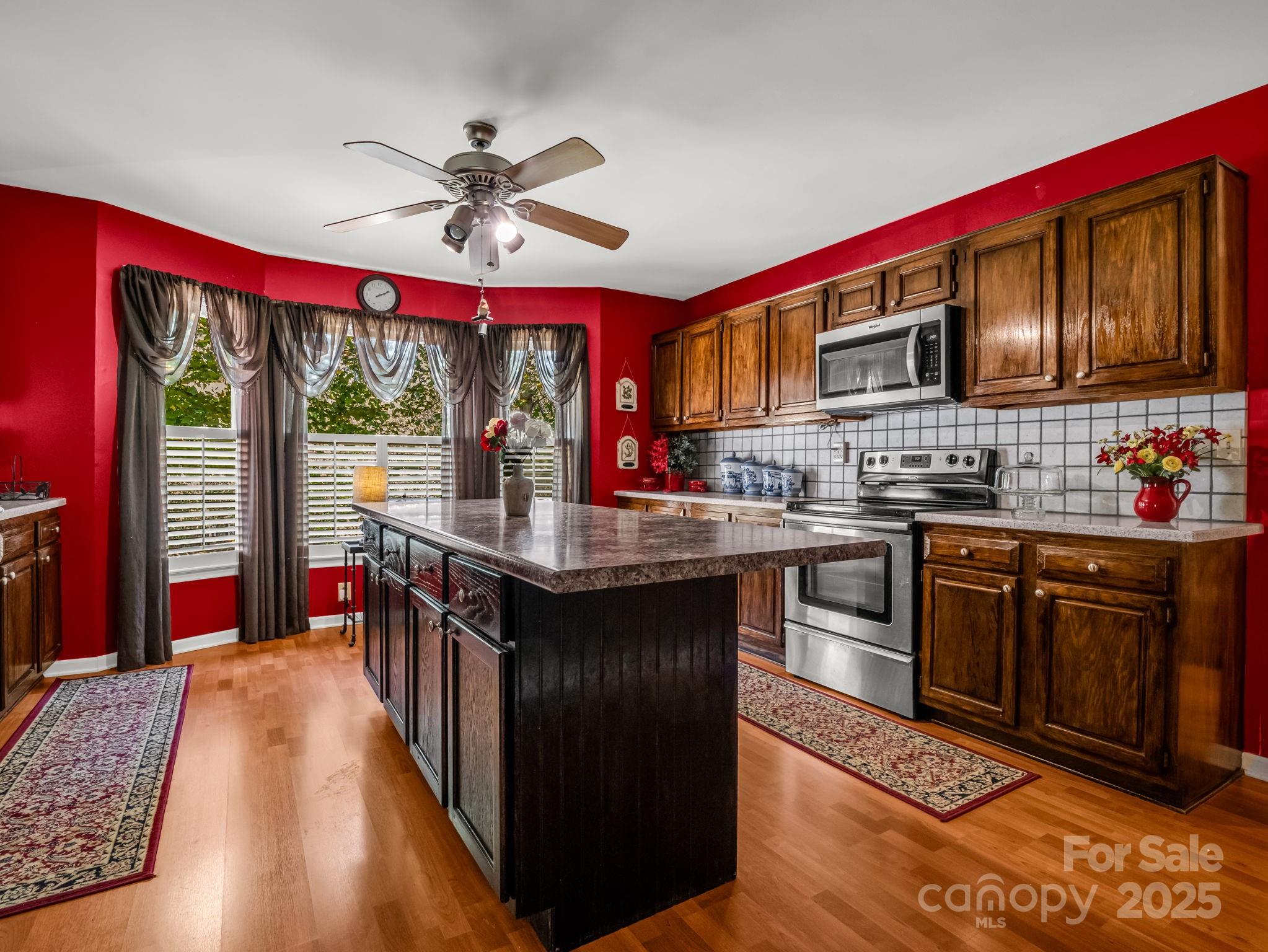 130 Briarwood Drive Rutherfordton, NC 28139 - Photo 8 of 48 a kitchen with stainless steel appliances granite countertop a stove a sink dishwasher and a refrigerator with wooden floor