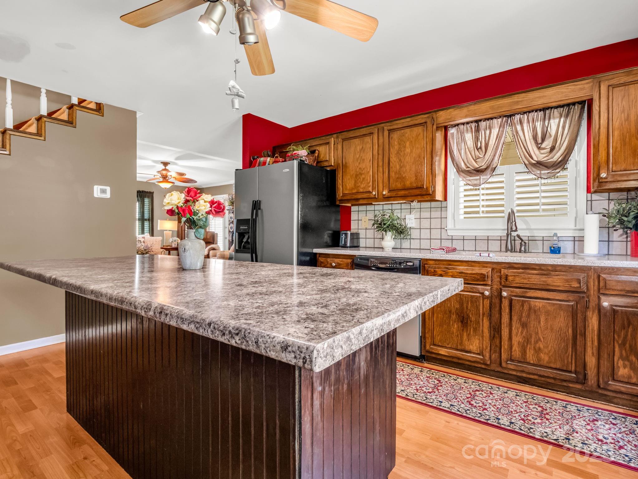 130 Briarwood Drive Rutherfordton, NC 28139 - Photo 9 of 48 a kitchen with stainless steel appliances granite countertop a sink dishwasher and a microwave with wooden floor