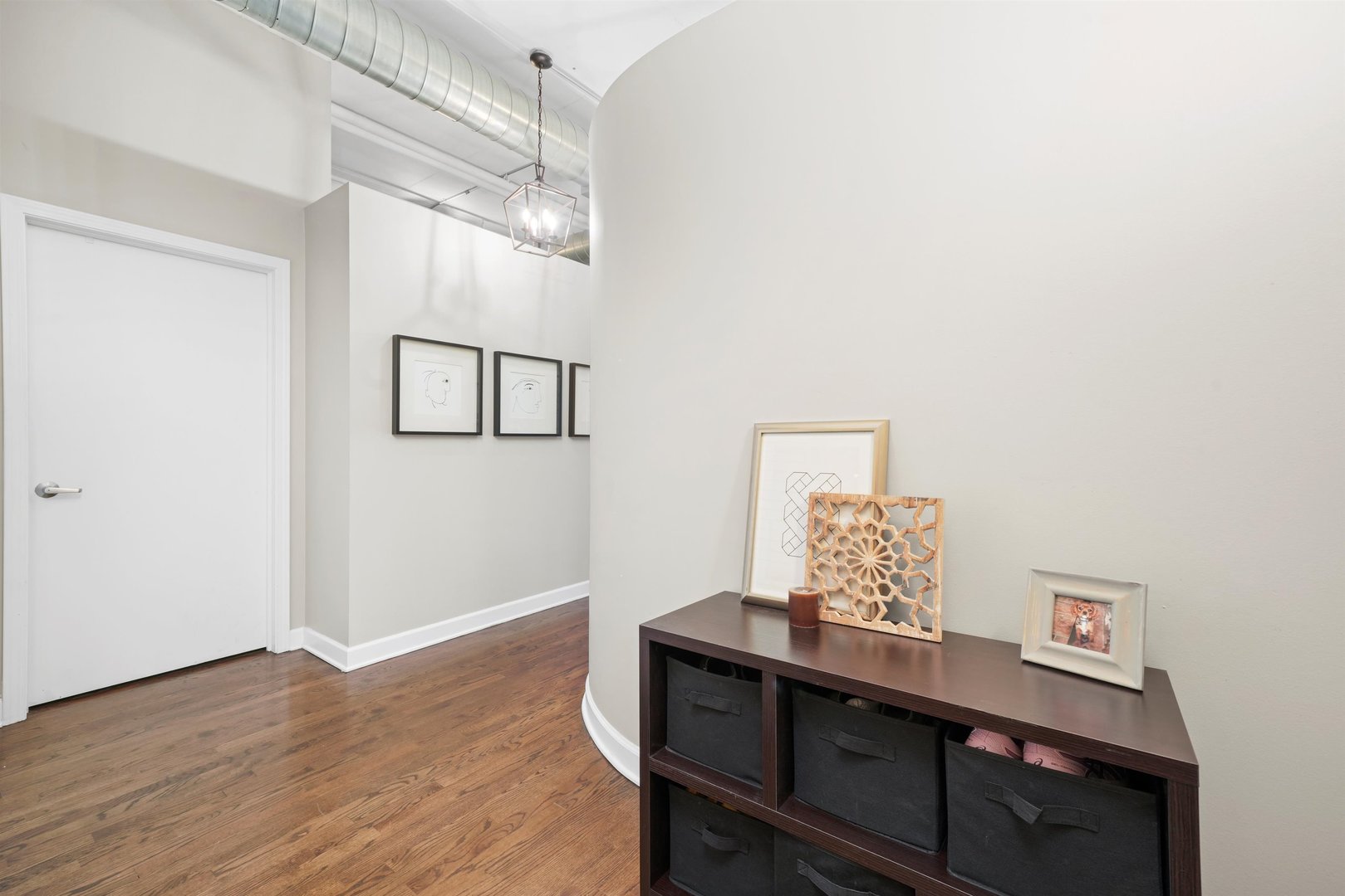 1301 West Madison Street, Unit 629 Chicago, IL 60607 - Photo 14 of 25 a room with a table and painting on the wall