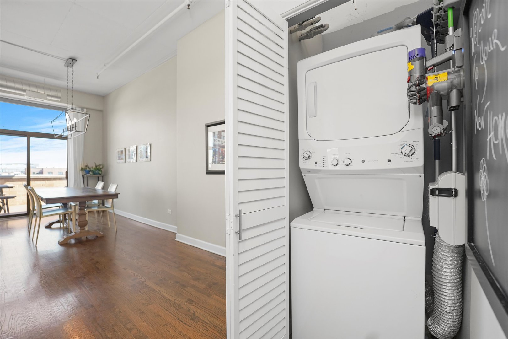 1301 West Madison Street, Unit 629 Chicago, IL 60607 - Photo 16 of 25 a view of washer and dryer with wooden floor