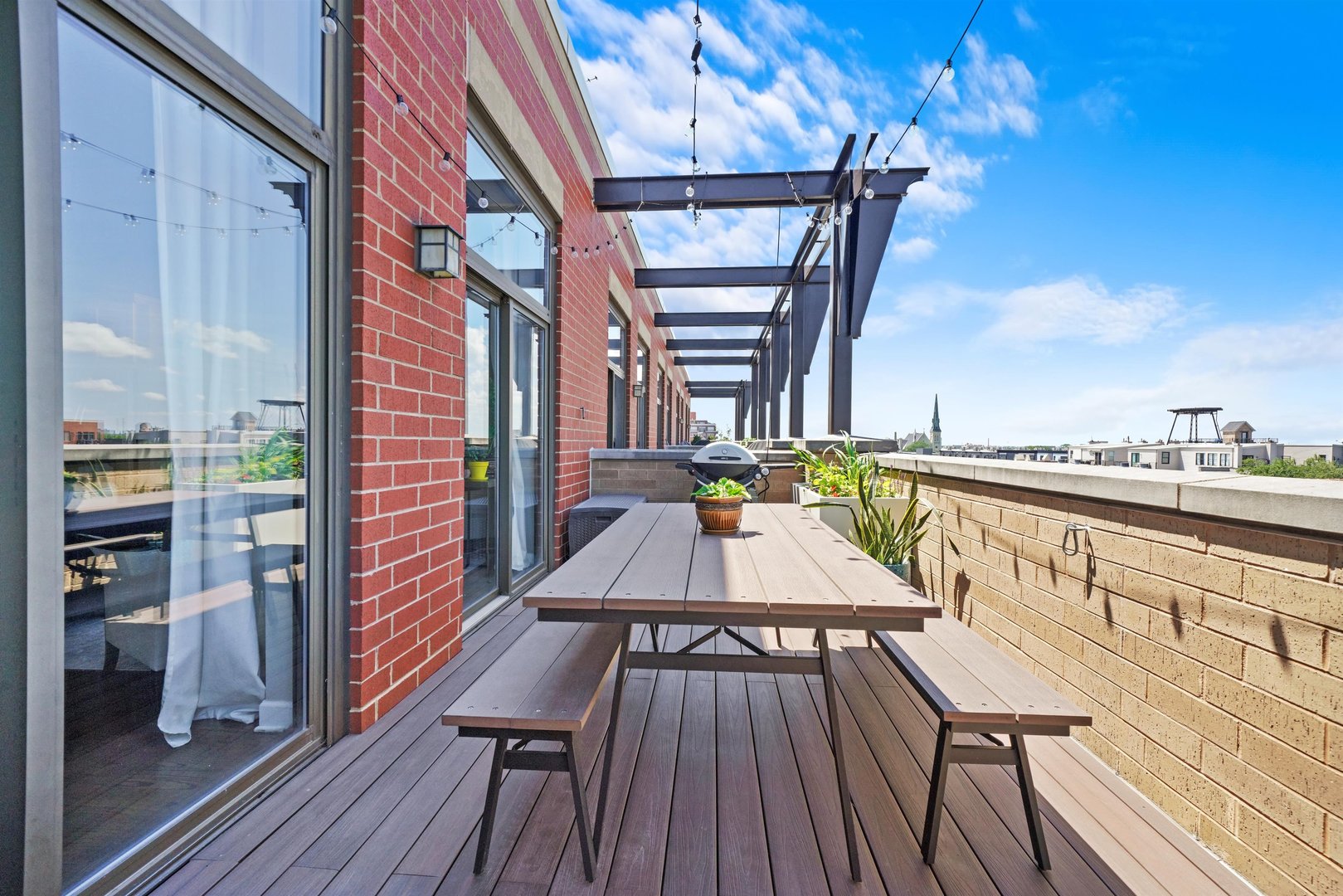 1301 West Madison Street, Unit 629 Chicago, IL 60607 - Photo 18 of 25 a view of a balcony with furniture and wooden floor